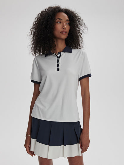 Varley Wisley Performance Polo Shirt in White/Blue Nights