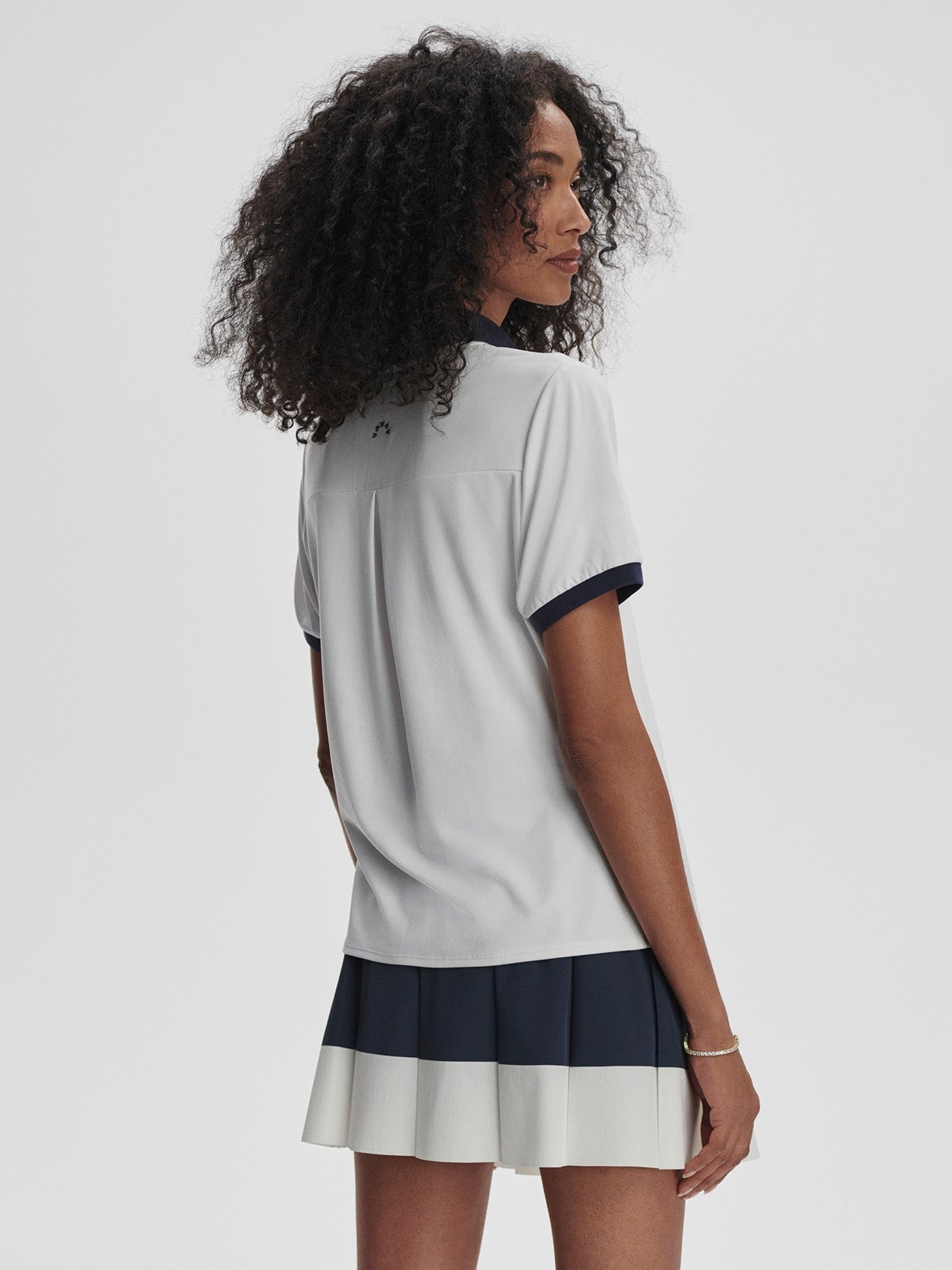 Varley Wisley Performance Polo Shirt in White/Blue Nights